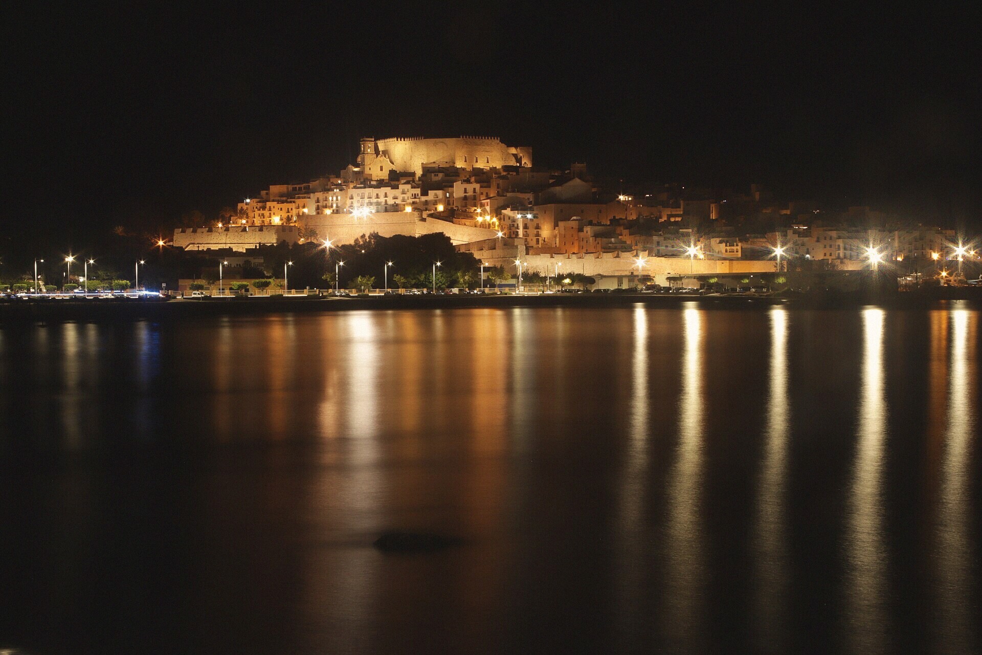 Peñíscola old town lit at night above the sea