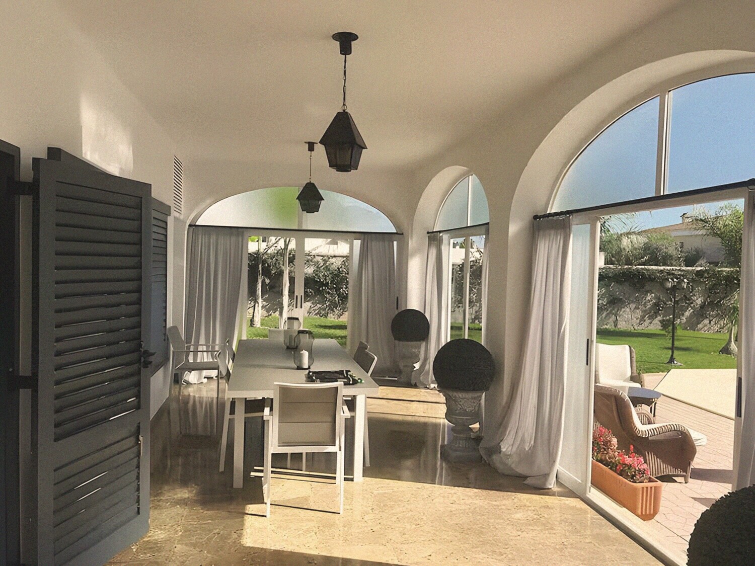 The arched sunroom opening to the garden